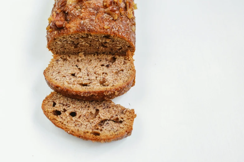 a sliced loaf of bread sitting on top of a white table, an album cover, pexels, cinnamon, banana, side view intricate details, high angle close up shot