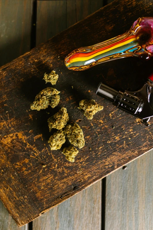 a bunch of marijuana sitting on top of a wooden table, a still life, unsplash, renaissance, dabbing, high quality product image”