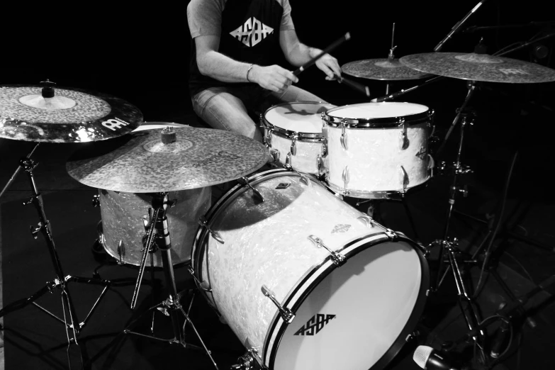 a black and white photo of a man playing drums, by Dicky Doyle, highly detailed # no filter, albino, uploaded, soft white rubber