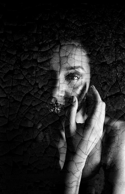 a black and white photo of a woman talking on a cell phone, a black and white photo, inspired by irakli nadar, pexels contest winner, art photography, subject made of cracked clay, fractal face, looking at you, woman