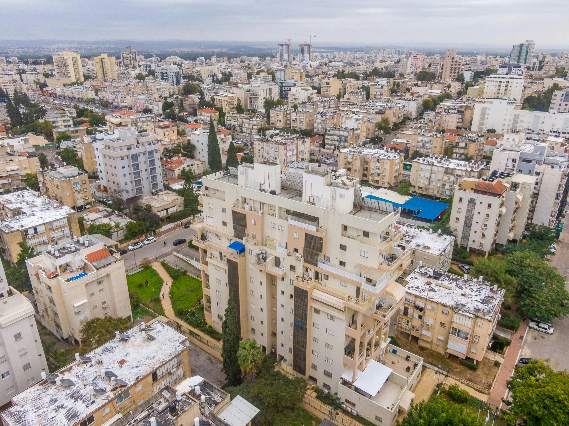 an aerial view of a city with lots of buildings, by Steven Belledin, unsplash, bauhaus, israel, ultrawide angle cinematic view, 2000s photo, concrete housing