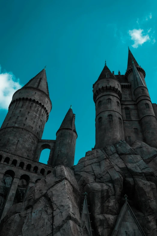 a castle with a blue sky in the background, harry potter, highly upvoted, grey, medium - shot