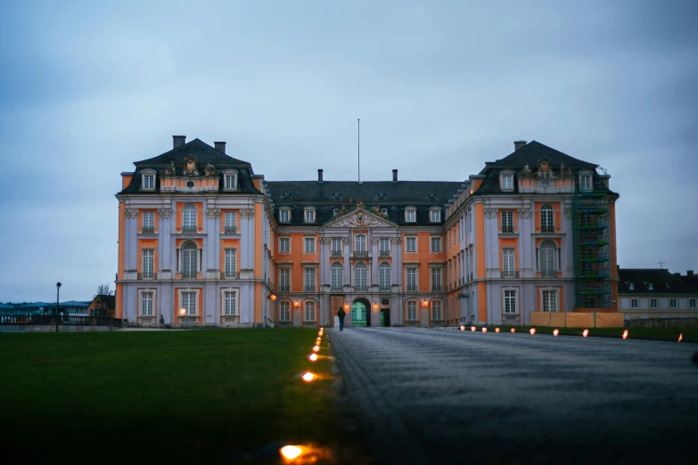 a large building sitting on top of a lush green field, an album cover, pexels contest winner, baroque, night photo, grey orange, detmold, royally decorated