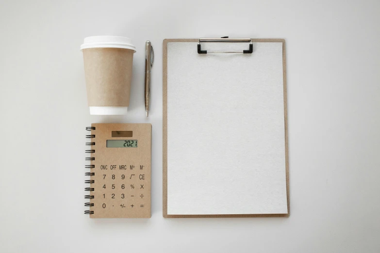 a cup of coffee next to a clipboard and a calculator, minimalism, 9 9 designs, brown, thumbnail, taken with sony alpha 9