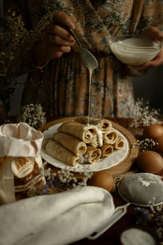 a woman standing in front of a table filled with food, inspired by Anka Zhuravleva, renaissance, pancakes, scrolls, close up food photography, cottagecore hippie