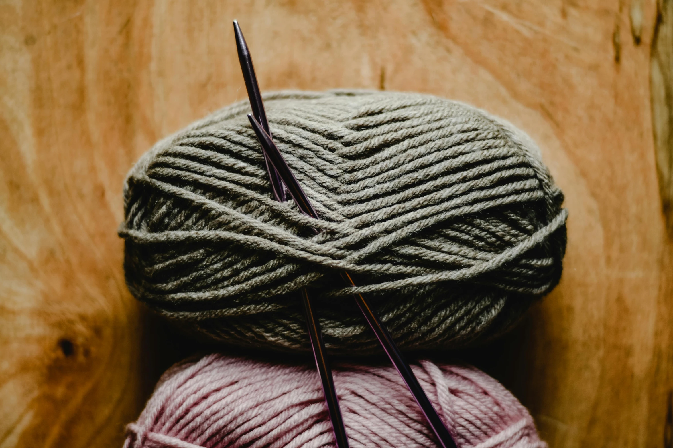 two balls of yarn and a pair of knitting needles, trending on pexels, avatar image, background image, cozy aesthetic, magenta and gray