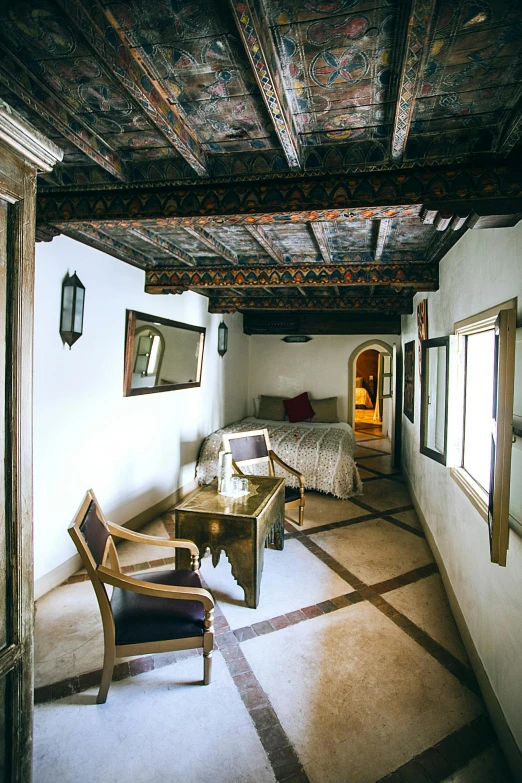 a living room filled with furniture and a wooden ceiling, inspired by Riad Beyrouti, renaissance, hotel room, a high angle shot, square, thumbnail