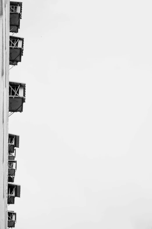 a black and white photo of a tall building, by Paolo Parente, unsplash contest winner, postminimalism, stage speakers, 256x256, sitting in a crane, in a row