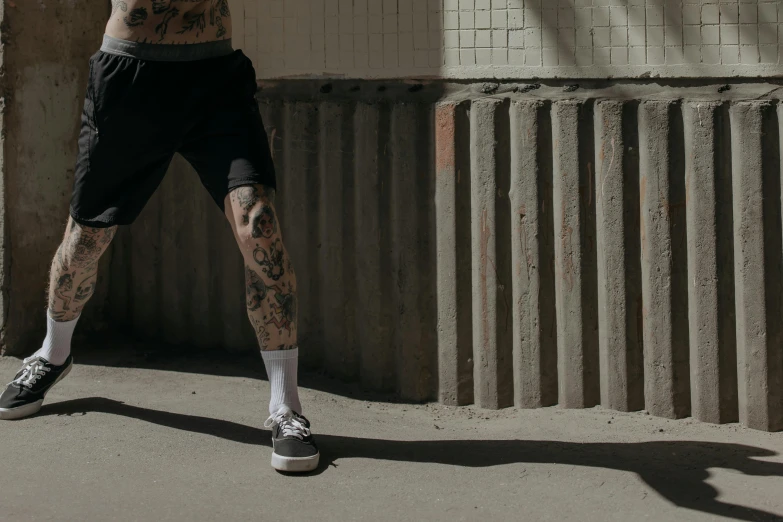 a man holding a tennis racquet on top of a tennis court, a tattoo, pexels contest winner, graffiti, tights; on the street, gif, thick legs, parkour