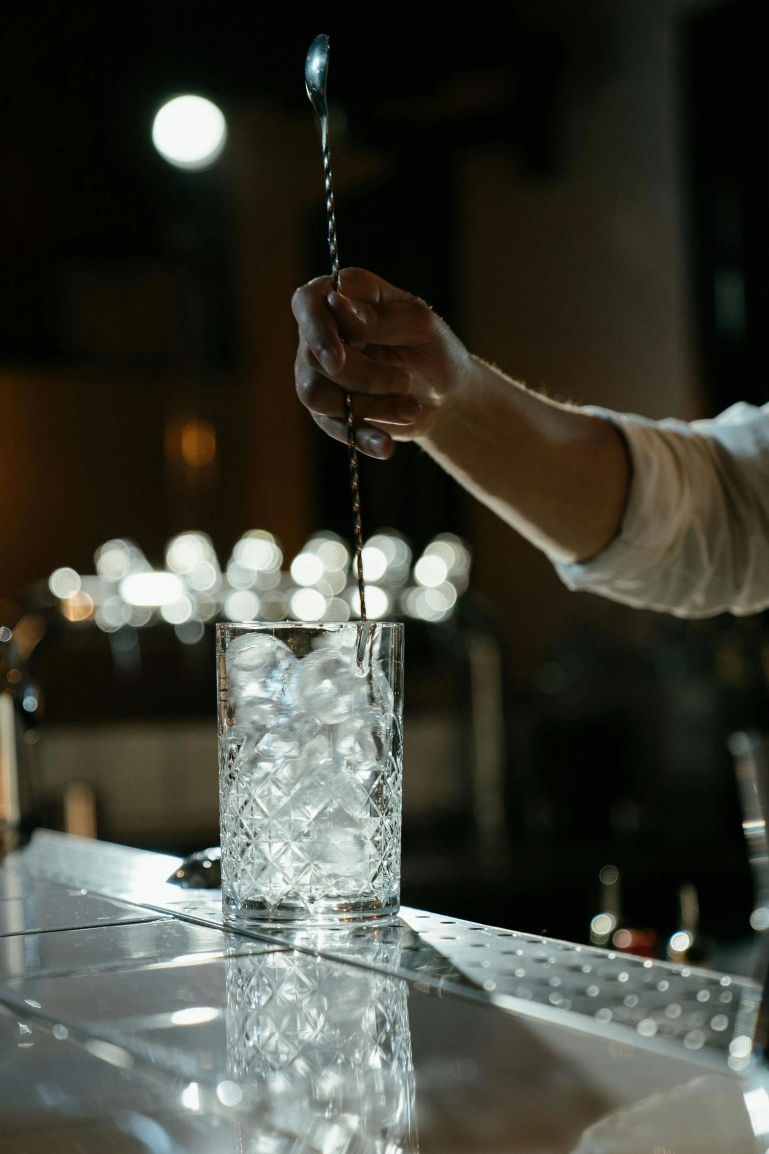 a person pouring a drink at a bar, icicle, subtle detailing, newton's cradle, ignant