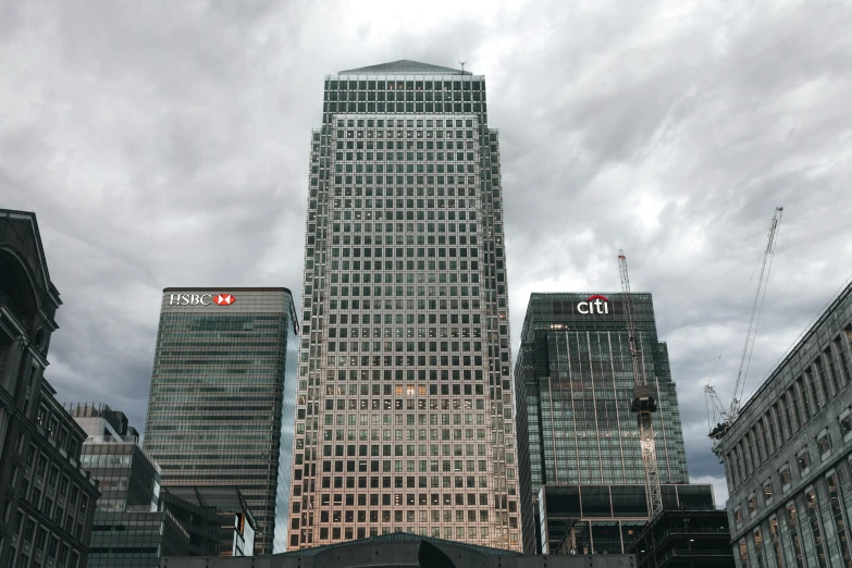 a group of people walking down a street next to tall buildings, pexels contest winner, hyperrealism, canary wharf, grey sky, photo taken from a boat, pizza skyscrapers
