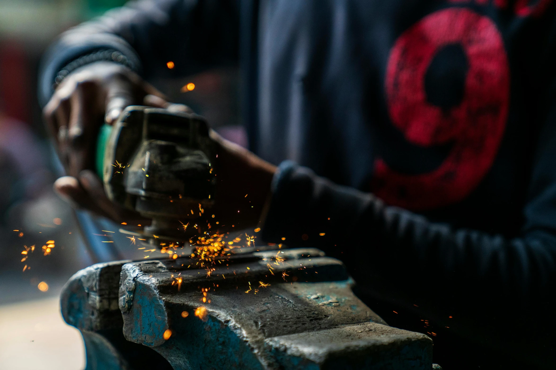 a man grinding a piece of metal with a grinder, by Daniel Lieske, pexels contest winner, avatar image, with damaged rusty arms, thumbnail, rhys lee