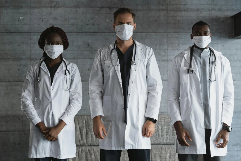 a group of doctors standing next to each other, a portrait, by Meredith Dillman, pexels contest winner, white man with black fabric mask, gray, white uniform, white