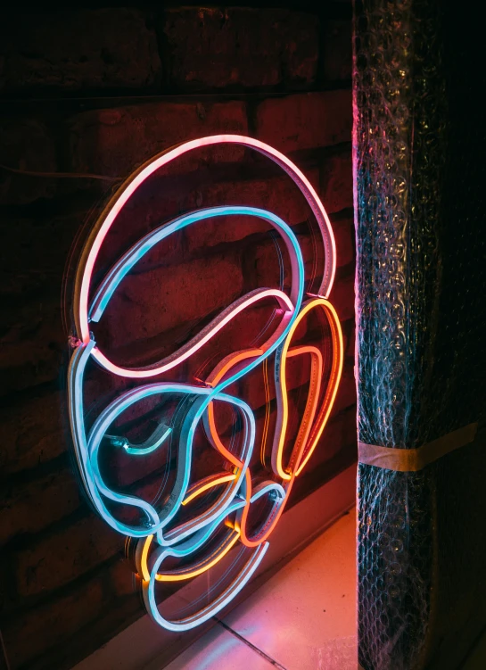 a neon sign sitting on the side of a building, an abstract sculpture, by Doug Ohlson, unsplash, star wars alien faces, cafe lighting, muted rainbow tubing, portrait photo