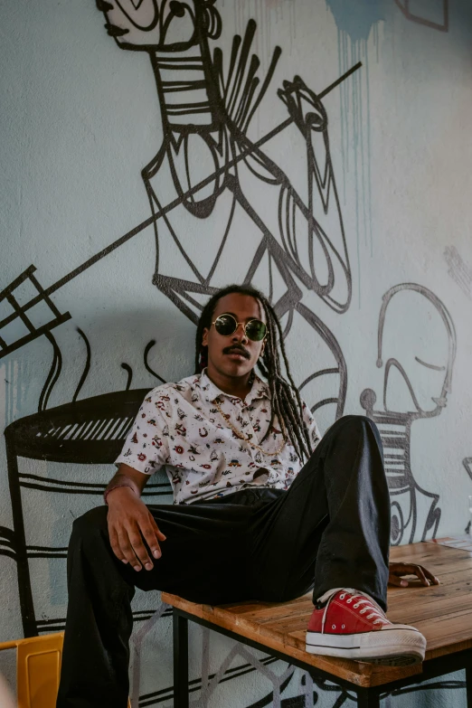 a man sitting on top of a wooden table, by Afewerk Tekle, trending on unsplash, visual art, graffiti in background, sitting on an armchair, playboi carti portrait, frank dillane