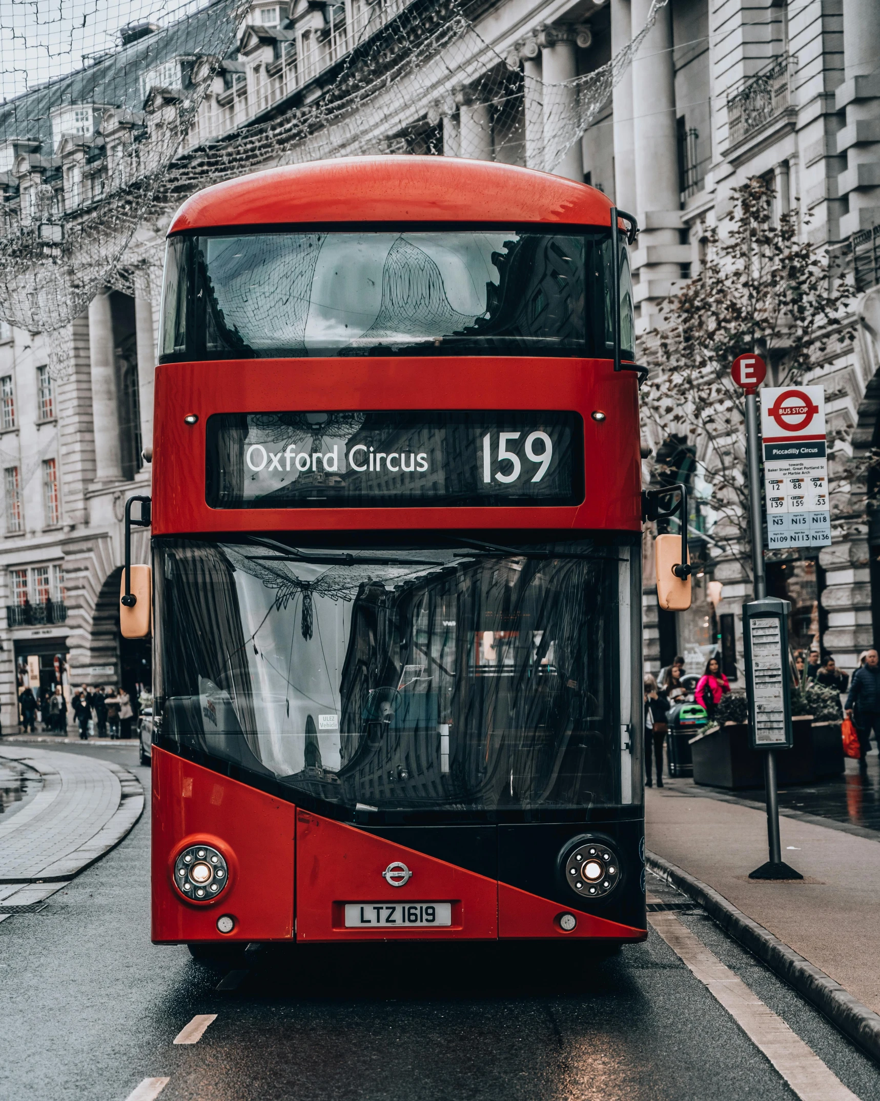 a red double decker bus driving down a street, pexels contest winner, square, 🚿🗝📝, viral image, heavily upvoted