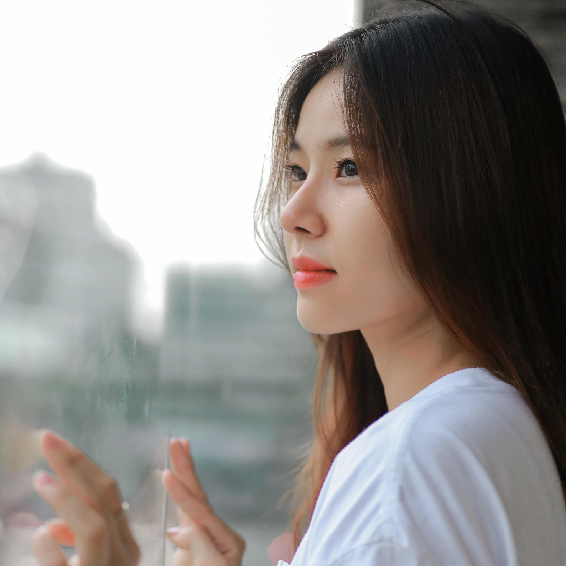 a beautiful young woman standing in front of a window, by Jang Seung-eop, pexels contest winner, realism, wan adorable korean face, pondering, korean idol, dressed in a white t shirt