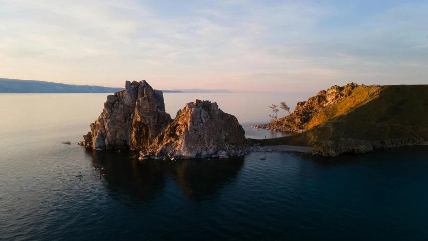 a rock formation in the middle of a body of water, near lake baikal, slide show, gigapixel photo, 4k press image