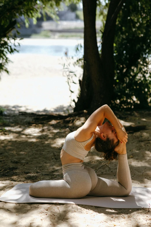 a woman doing a yoga pose in the woods, unsplash, arabesque, in a beachfront environment, soft shade, contorted, white