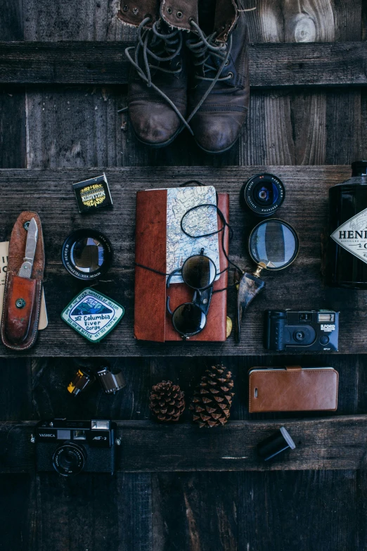 a variety of items laid out on a wooden floor, trending on unsplash, assemblage, portrait of an adventurer, products shot, look like model, black