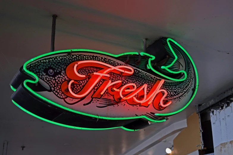 a neon sign hanging from the side of a building, fish hooks, fresh fruit, red and green lighting, great high details