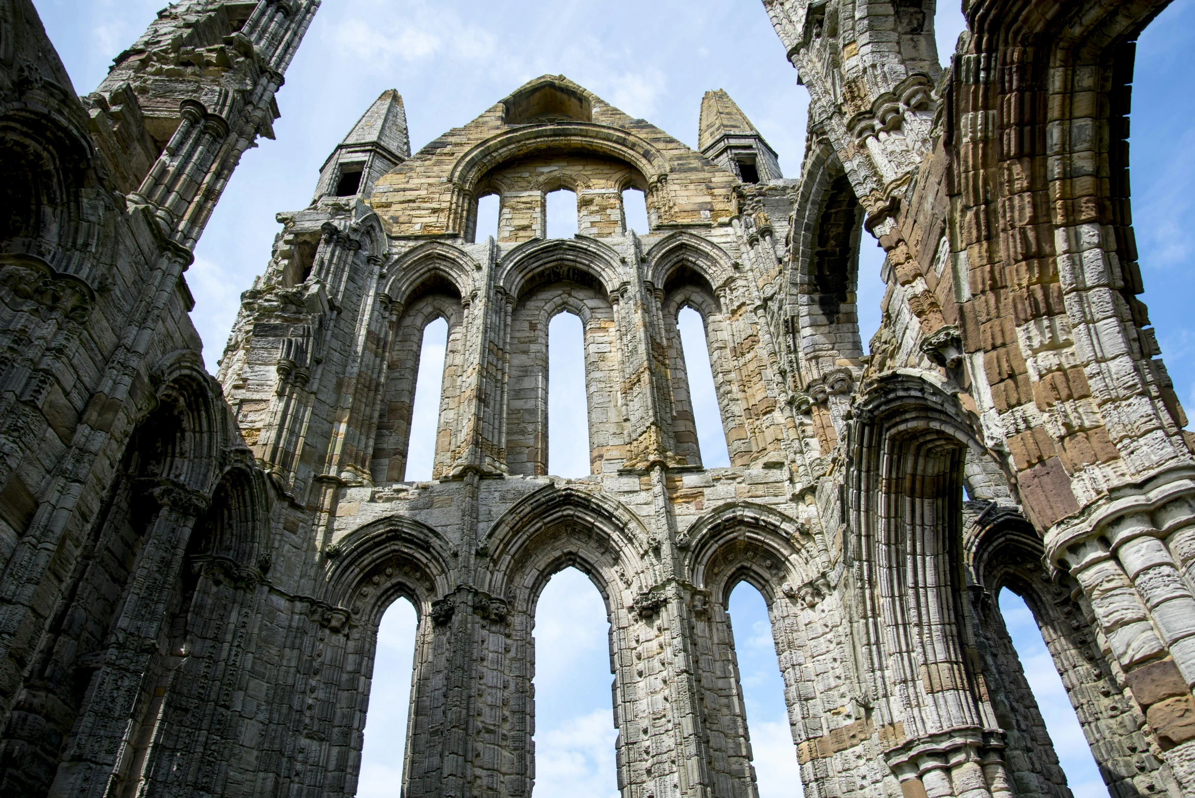 a view of the inside of an old building, by Kev Walker, pexels contest winner, romanesque, huge support buttresses, yorkshire, sunny day, grey