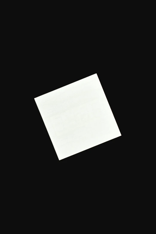 a black and white photo of a square of paper, by Albert Welti, unsplash, white on black, ffffound, everyday plain object, miniature product photo