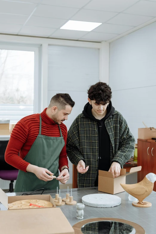 a couple of men standing next to each other in a room, arbeitsrat für kunst, crafting, box, student, plating