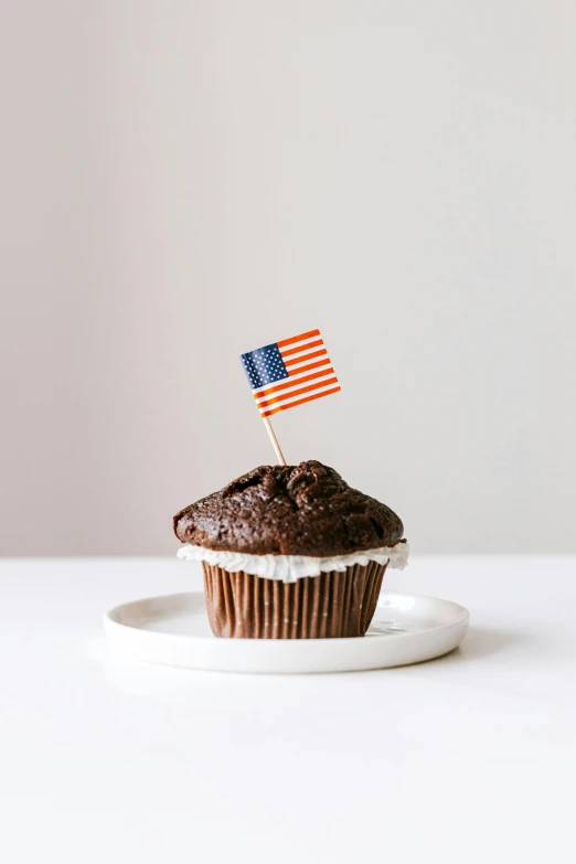 a cupcake with an american flag on top of it, unsplash, high resolution product photo, 🚿🗝📝