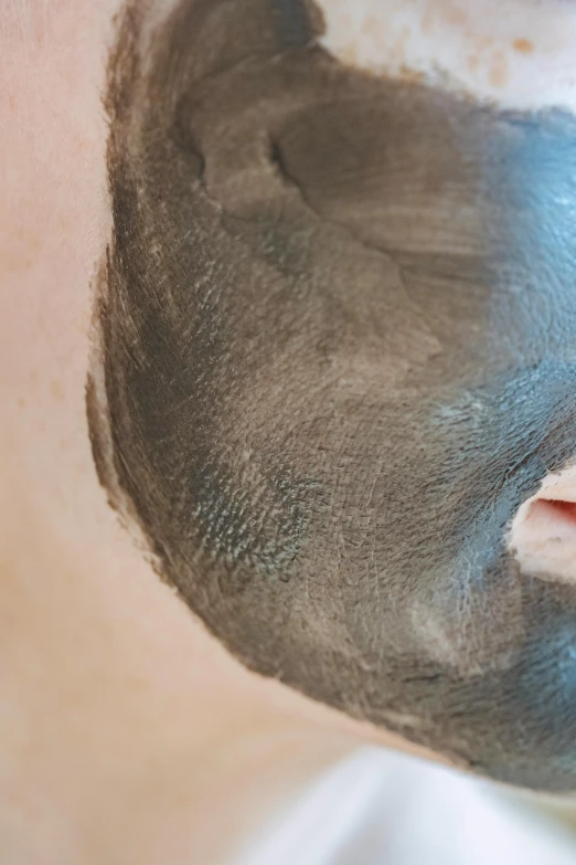 a close up of a person with a face mask on, charcoal color skin, pronounced facial contouring, bottom body close up, facial