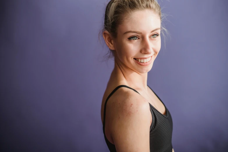 a woman posing for a picture in a black leo leo leo leo leo leo leo leo leo leo leo leo leo leo leo leo, by Lee Loughridge, pexels contest winner, smooth purple skin, athletic muscle tone, sydney sweeney, smiling down from above