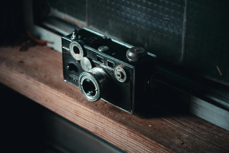 an old camera sitting on a window sill, on a wooden desk, steampunk aesthetic, 3 2 mm photograph, unsplash 4k