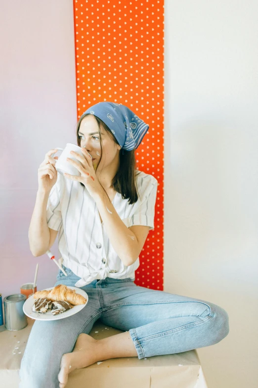 a woman sitting on a stool with a plate of food, bandanas, woman drinking coffee, gen z, profile image