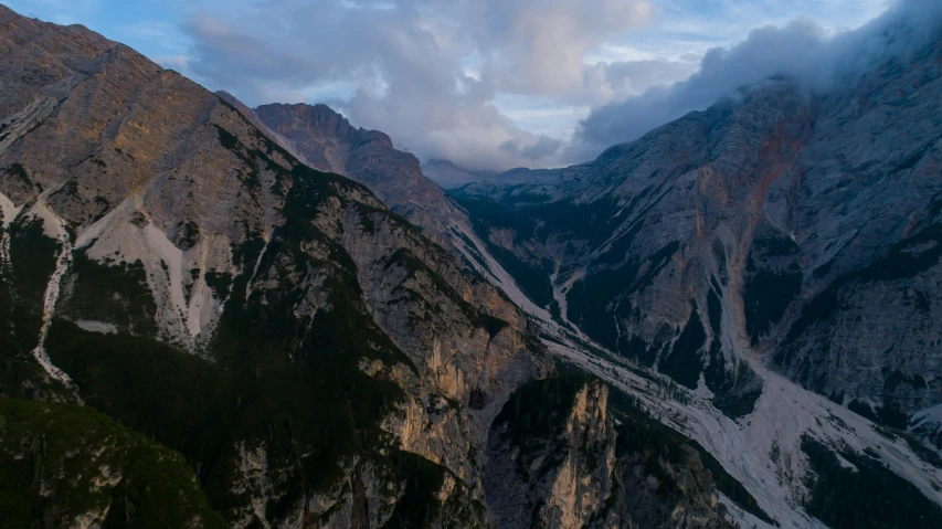 a view of the mountains from the top of a mountain, by Sebastian Spreng, pexels contest winner, renaissance, cliff side at dusk, aerial shot from the drone, italy, zoomed out view