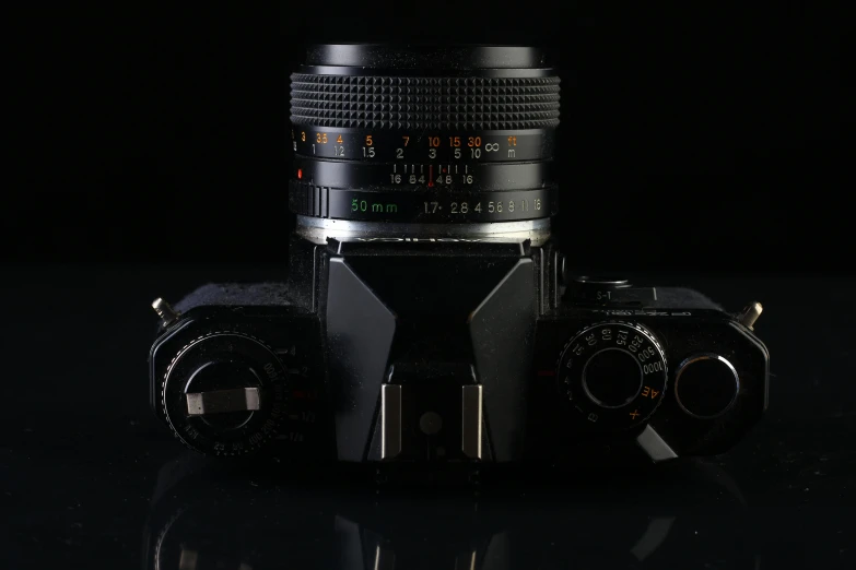a close up of a camera on a table, in front of a black background, hyperrealistic n- 4, f / 1 1. 0, f / 1. 2 5