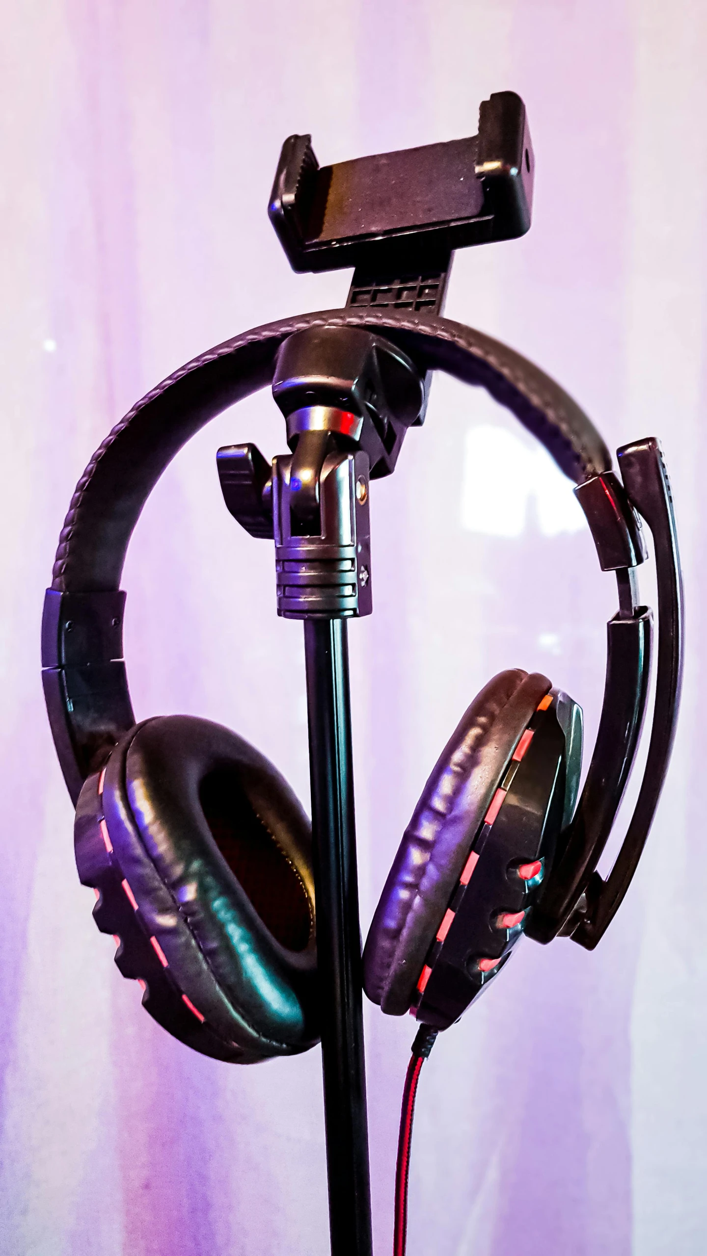 a pair of headphones sitting on top of a tripod, by Everett Warner, pexels, pop art, led gaming, detailed studio photograph, upright, tall