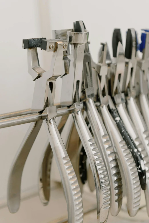 a bunch of pliers are hanging on a rack, profile image