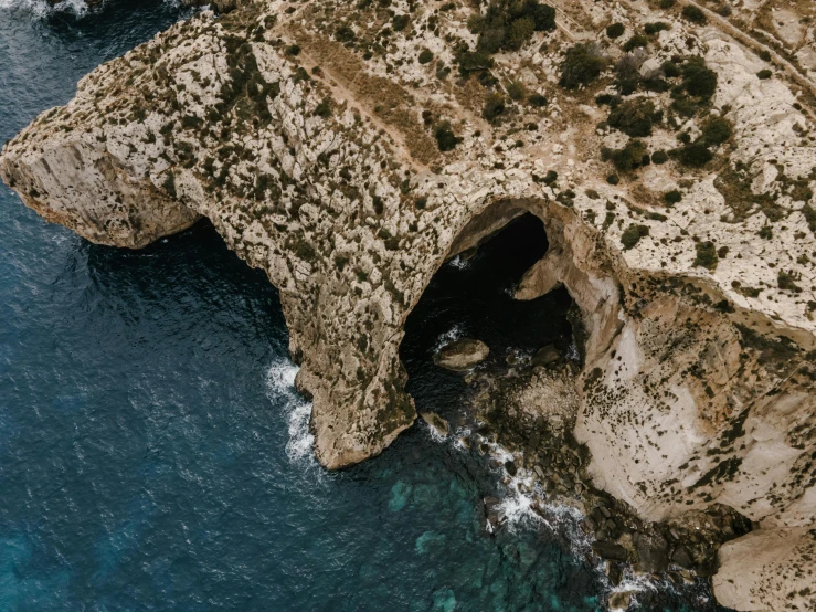 a cave in the middle of a body of water, pexels contest winner, les nabis, apulia, high angle close up shot, rock arcs, cyprus