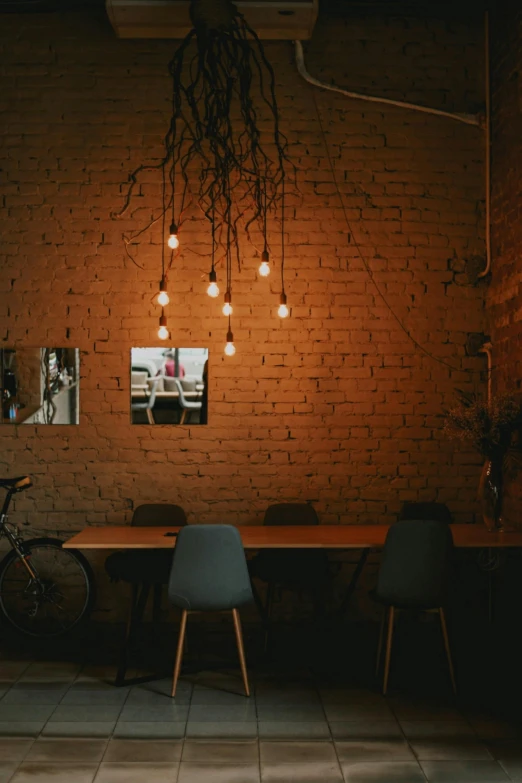 a table and chairs in a room with a brick wall, a portrait, by Jan Tengnagel, pexels contest winner, light and space, cafe lighting, decoration around the room, plain background, low quality photo