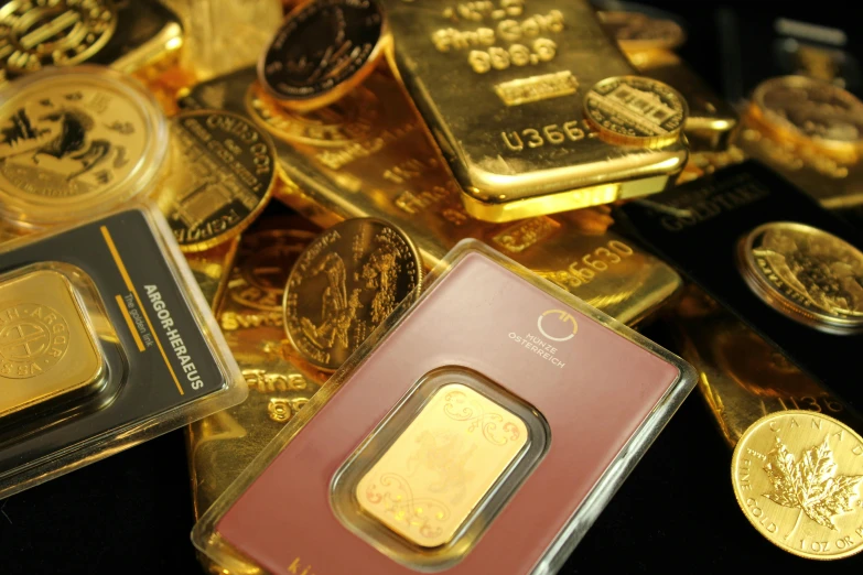 a pile of gold bars sitting on top of a table, medallions, thumbnail, album, reuters