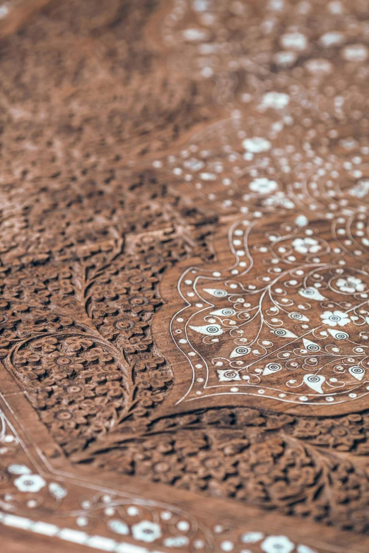 a close up of a table cloth on a table, arabesque, hand carved brown resin, intricate scenery, laser cut, detailed product shot