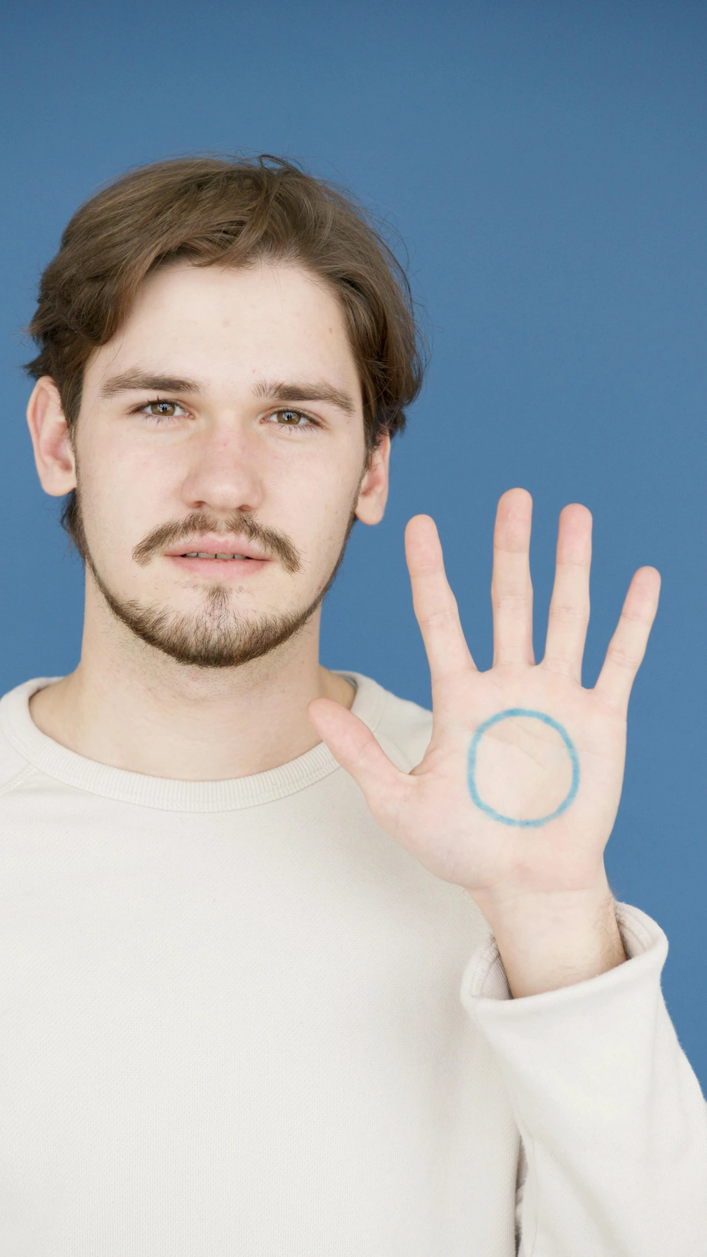 a man making a stop sign with his hand, by Arabella Rankin, trending on reddit, with blue skin, symmetrical face orelsan, enso, circles