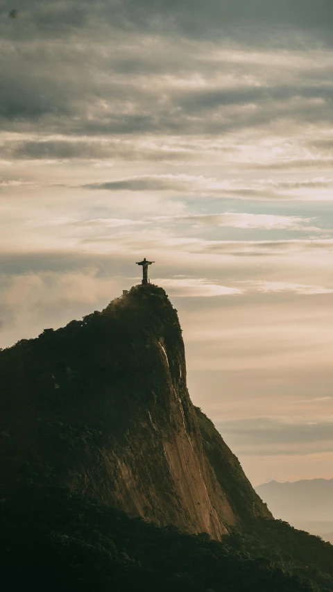 a cross on top of a mountain on a cloudy day, pexels contest winner, romanticism, president of brazil, taken at golden hour, grey, single