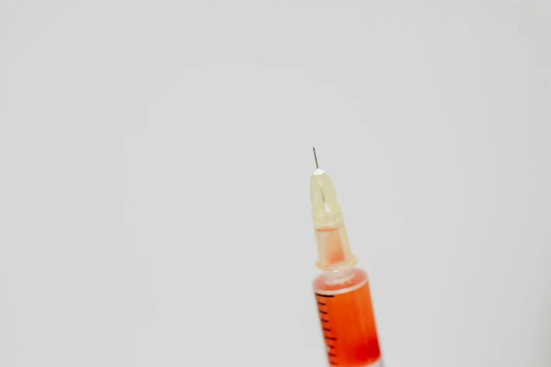 a syll with a needle sticking out of it, by Emma Andijewska, pexels, syringe, background image, miniature product photo, 15081959 21121991 01012000 4k