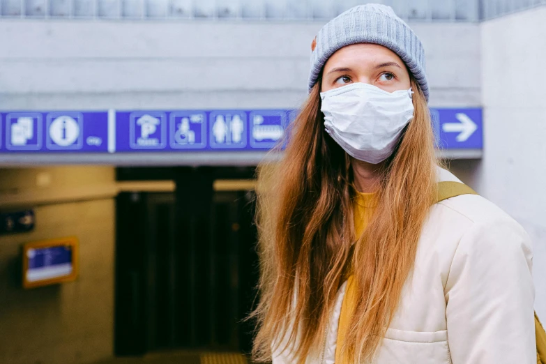 a woman wearing a face mask in a subway station, a picture, by Emma Andijewska, shutterstock, square, beauty is a virus, ski masks, thumbnail