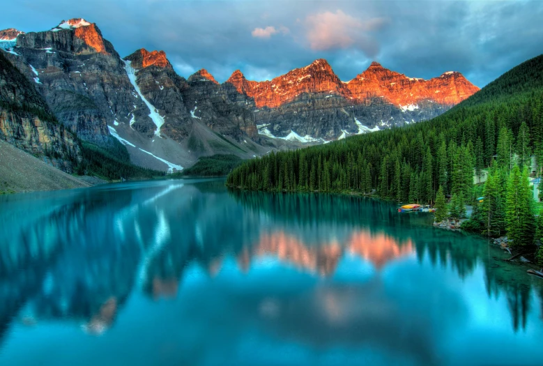 a lake surrounded by trees with mountains in the background, pexels contest winner, national geographics, banff national park, beautiful lit, grand majestic mountains