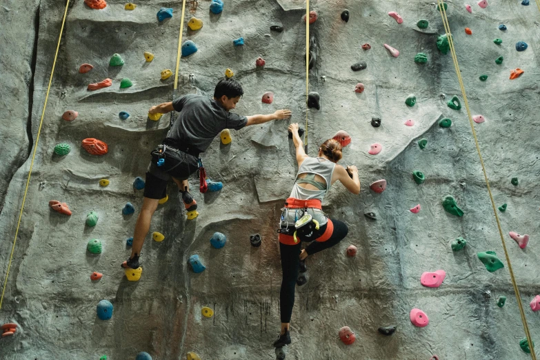 a man and a woman climbing on a rock wall, pexels contest winner, biodome, 15081959 21121991 01012000 4k, asia, massive vertical grand prix race