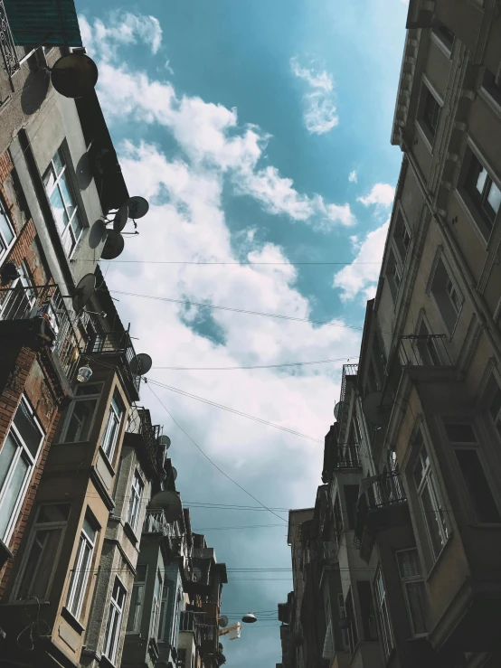 a couple of tall buildings next to each other, by Lucia Peka, unsplash contest winner, renaissance, shady alleys, summer sky, nika maisuradze, trending on vsco