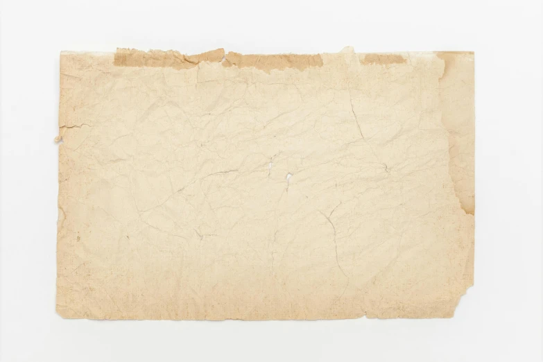 an old piece of paper on a white surface, by Joseph Beuys, unsplash, 1 9 0 0 s photograph, background image, australia, 5 7 9