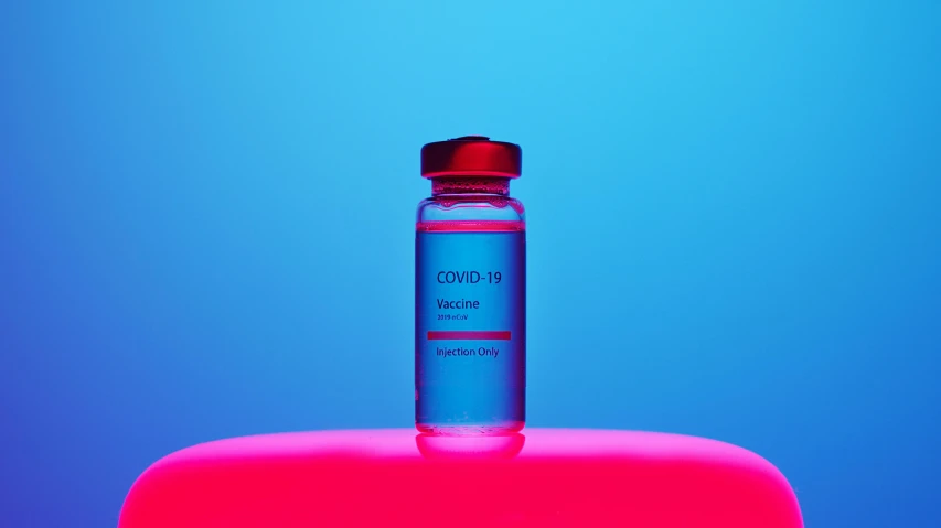 a bottle of water sitting on top of a table, a picture, blue and red, medical image, thumbnail, purple and blue neons